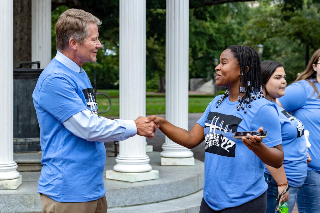 Students in the Summer Bridge program meet with Chancellor Kevin M. Guskiewicz on July 25, 2022, at the Old Well on the campus of the University of North Carolina at Chapel Hill.